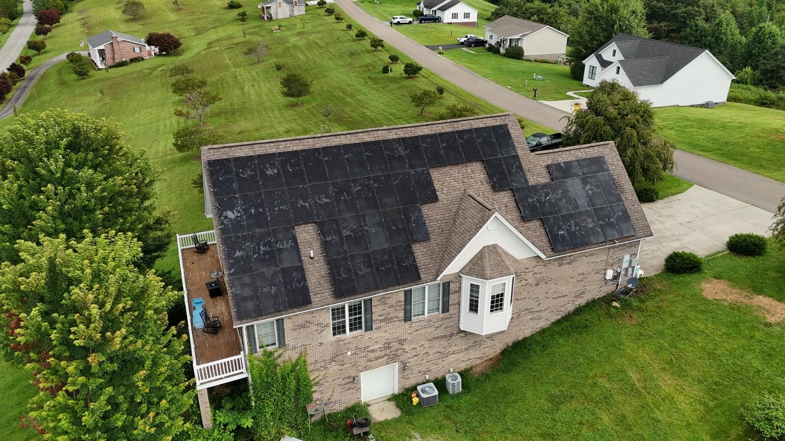 Close aerial view of a multi-surface residential solar array